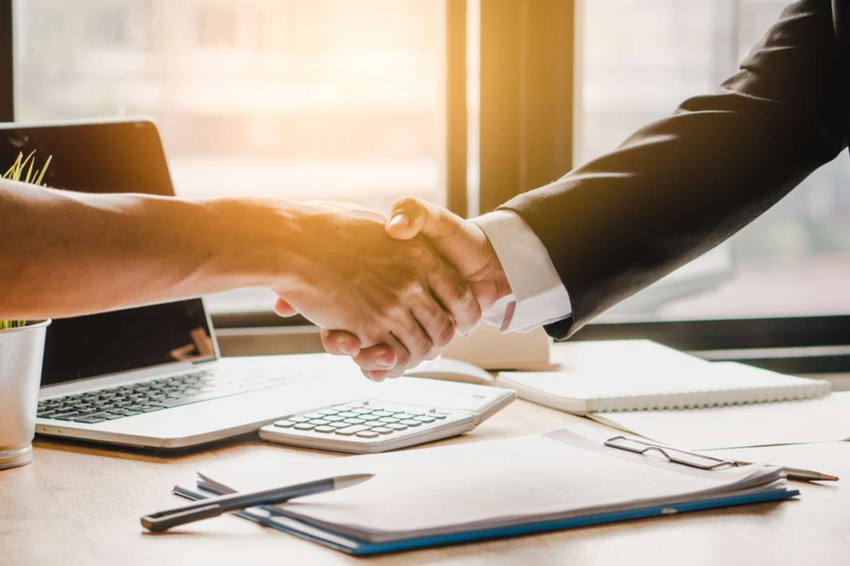 Close up handshake of business people in meeting attendance